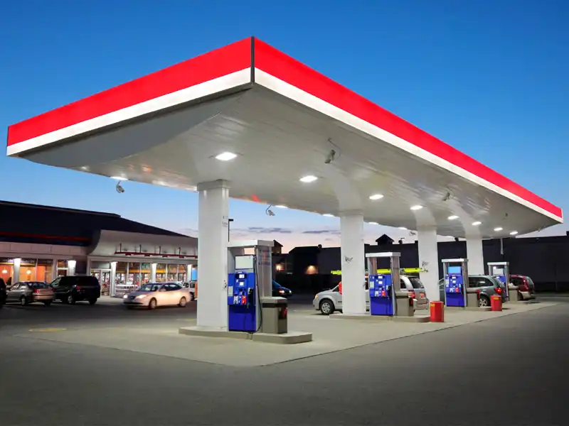 Nighttime view of a brightly lit red & white gas station in the Louisville area represents HurriClean's 24-hour Fuel Station pressure washing service.