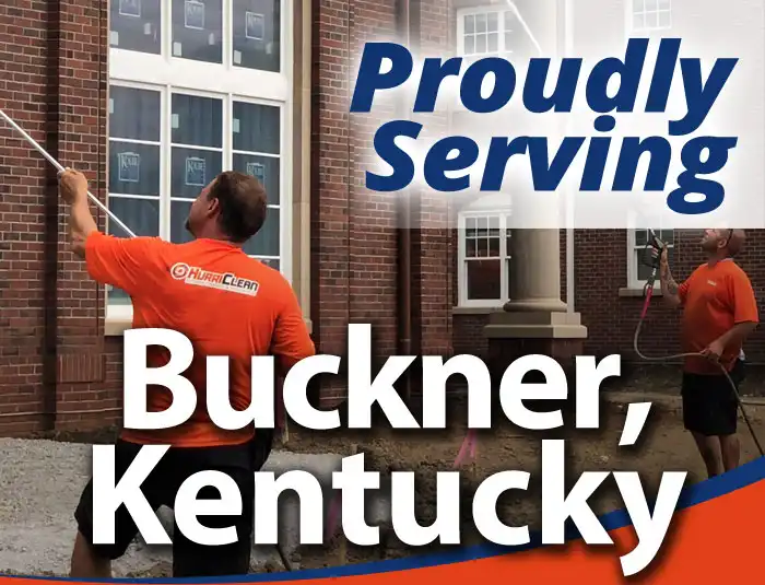 HurriClean workers wearing bright orange shirts soft washing a brick building with text overlay that reads Proudly Serving Buckner, Kentucky.