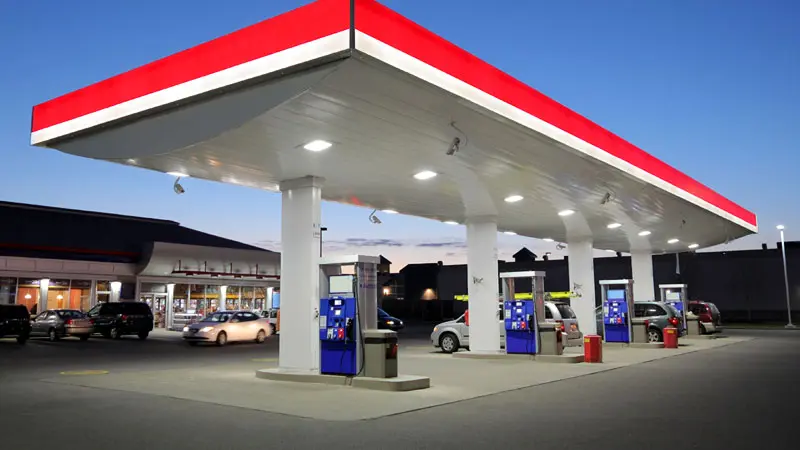 A gas station with a freshly cleaned red and white canopy and pump islands represents HurriClean Pressure Washing's Fuel Station Cleaning service available in the Crestwood, KY area.