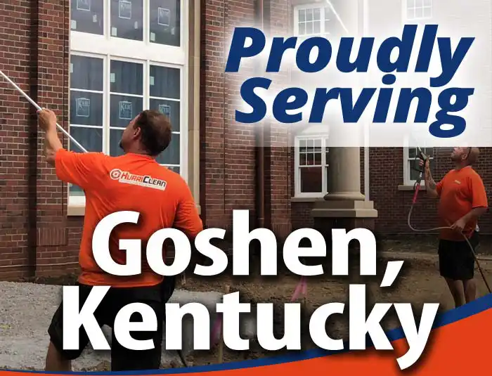 HurriClean building washing technicians wearing bright orange company shirts soft washing a brick facade with overlaid text that reads 'Proudly Serving Goshen, Kentucky'.