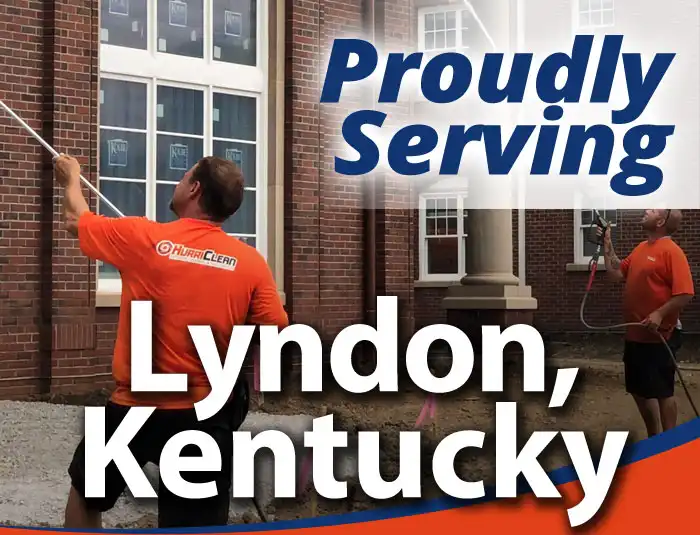HurriClean workers clad in bright orange logo shirts soft washing a brick building with overlaid text that reads Proudly Serving Lyndon, Kentucky.