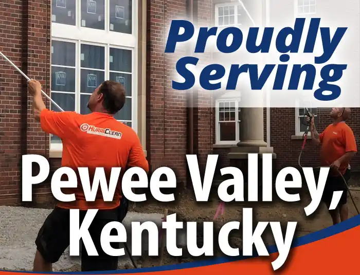 A team of HurriClean workers wearing orange compoany shirts soft washing a brick building facade with a text overlay that reads Proudly Serving Pewee Valley, Kentucky.