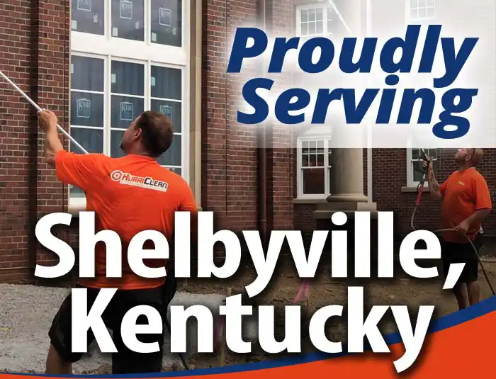 HurriClean technicians washing a building. They are wearing bright orange company shirts. Overlaid text that reads 'Proudly Serving Shelbyville, Kentucky'.