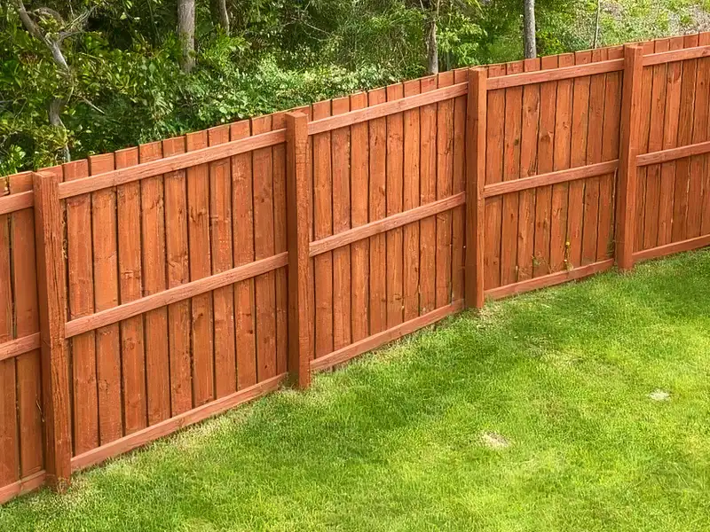 An aerial view of a redwood color stained wooden backyard privacy fence in the Lyndon KY area.