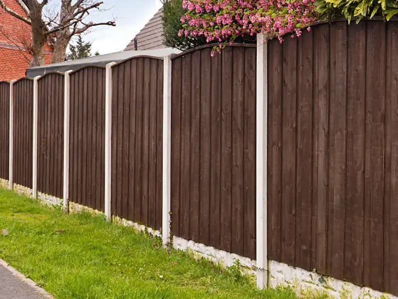 A mahogany color stained perimeter privacy fence with masonry footings and dividers in the Mt Washington KY area.